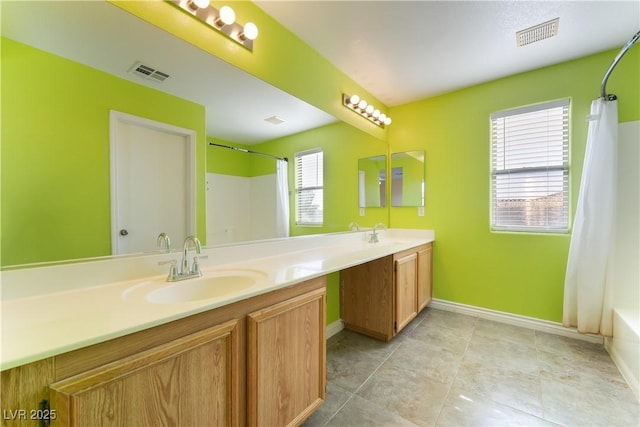 9753 Villa Lorena Ave, Las Vegas, NV 89147 - full bathroom with double vanity, baseboards, shower / tub combo with curtain, and tile patterned flooring