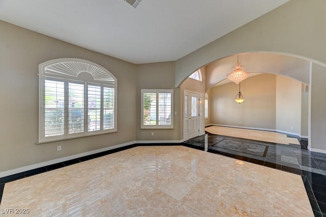 7540 Crystal Cave Dr, Las Vegas, NV 89117 - spare room featuring arched walkways and inlaid floor details
