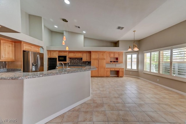7540 Crystal Cave Dr, Las Vegas, NV 89117 - kitchen featuring black appliances, a peninsula, light stone counters, light tile patterned flooring, and high vaulted ceiling