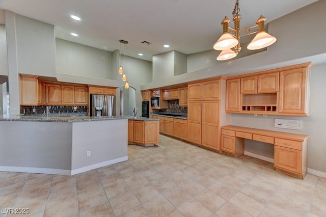 7540 Crystal Cave Dr, Las Vegas, NV 89117 - kitchen featuring stainless steel fridge with ice dispenser, tasteful backsplash, recessed lighting, a high ceiling, and black microwave