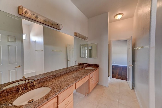 7540 Crystal Cave Dr, Las Vegas, NV 89117 - bathroom featuring double vanity, tile patterned flooring, baseboards, and a bathtub