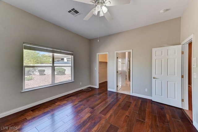 7540 Crystal Cave Dr, Las Vegas, NV 89117 - unfurnished bedroom featuring a spacious closet, dark wood finished floors, and ceiling fan