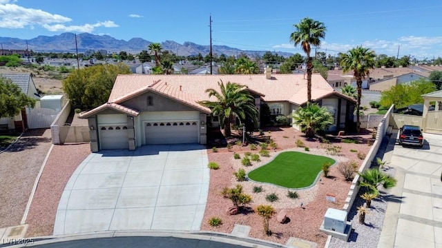 7540 Crystal Cave Dr, Las Vegas, NV 89117 - ranch-style home with an attached garage, a tiled roof, concrete driveway, a mountain view, and stucco siding