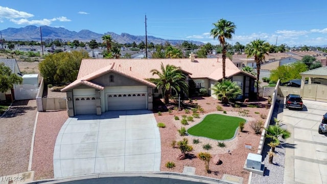 7540 Crystal Cave Dr, Las Vegas, NV 89117 - ranch-style home with an attached garage, concrete driveway, a tile roof, a mountain view, and stucco siding
