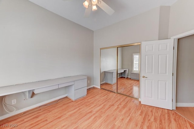 7540 Crystal Cave Dr, Las Vegas, NV 89117 - unfurnished bedroom with wood finished floors, a closet, a ceiling fan, and an office area