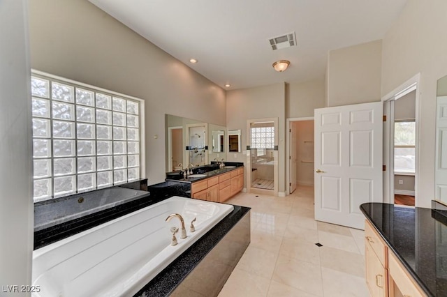 7540 Crystal Cave Dr, Las Vegas, NV 89117 - bathroom featuring a bath, vanity, a shower stall, and tile patterned floors