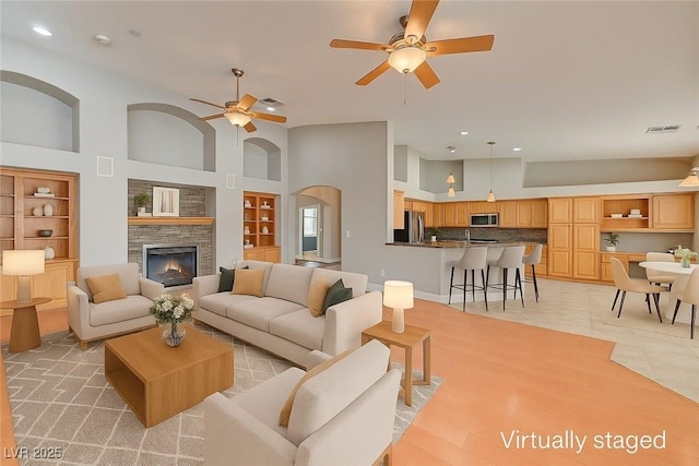 7540 Crystal Cave Dr, Las Vegas, NV 89117 - living room featuring ceiling fan, high vaulted ceiling, recessed lighting, a fireplace, and built in features