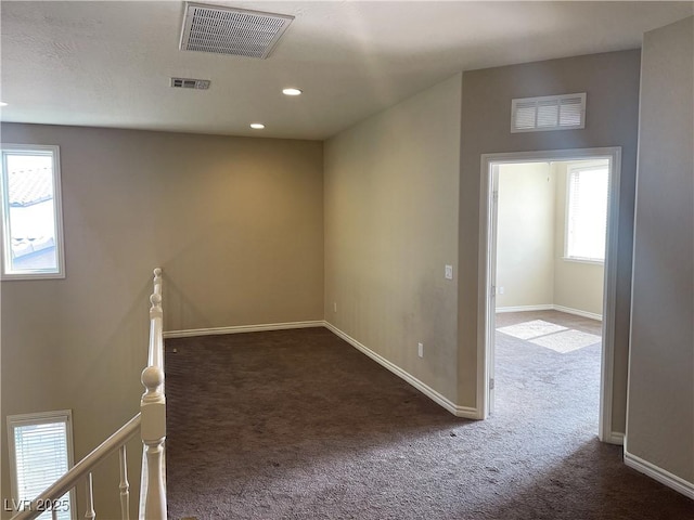 carpeted empty room featuring baseboards and recessed lighting