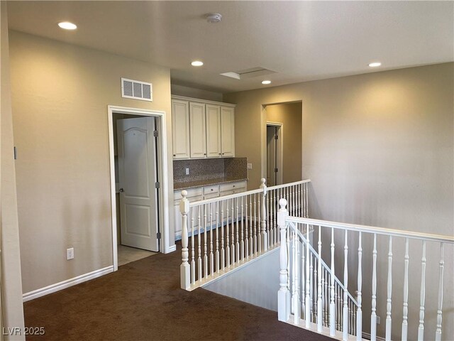 corridor with an upstairs landing, carpet, recessed lighting, and baseboards