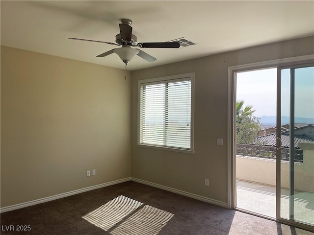 spare room with healthy amount of natural light, carpet, baseboards, and a ceiling fan