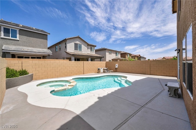 view of pool featuring a patio area, a fenced backyard, a pool with connected hot tub, and a residential view
