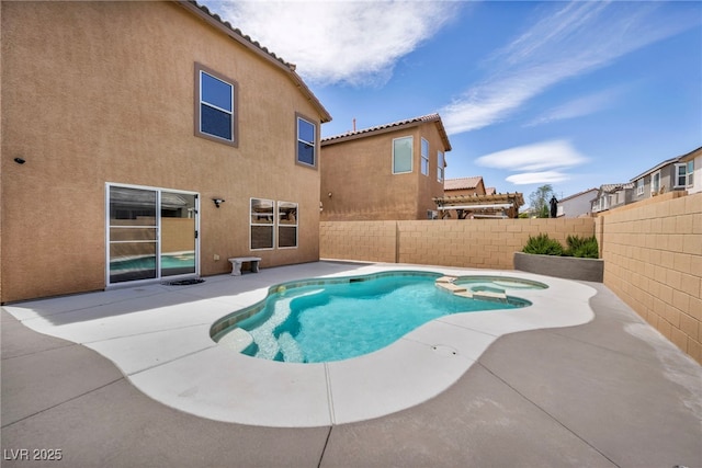 view of pool with a patio area, a fenced backyard, and a pool with connected hot tub