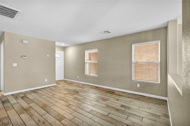 unfurnished room with wood finished floors and baseboards