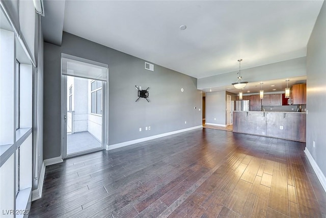 150 Las Vegas Blvd Unit 2016, North Las Vegas, NV 89101 - unfurnished living room featuring dark wood-style floors and baseboards