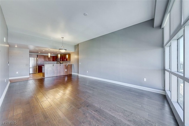 150 Las Vegas Blvd Unit 2016, North Las Vegas, NV 89101 - unfurnished living room featuring baseboards and dark wood-style flooring
