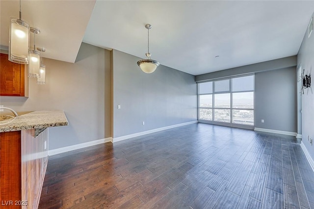 150 Las Vegas Blvd Unit 2016, North Las Vegas, NV 89101 - unfurnished living room featuring dark wood-style floors and baseboards