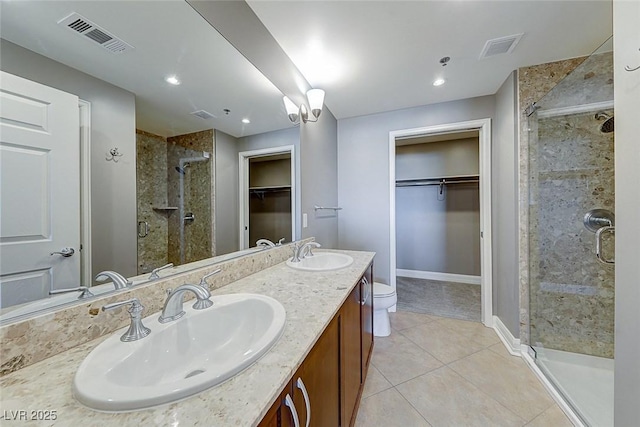 150 Las Vegas Blvd Unit 2016, North Las Vegas, NV 89101 - full bathroom featuring a stall shower, tile patterned flooring, a walk in closet, double vanity, and baseboards