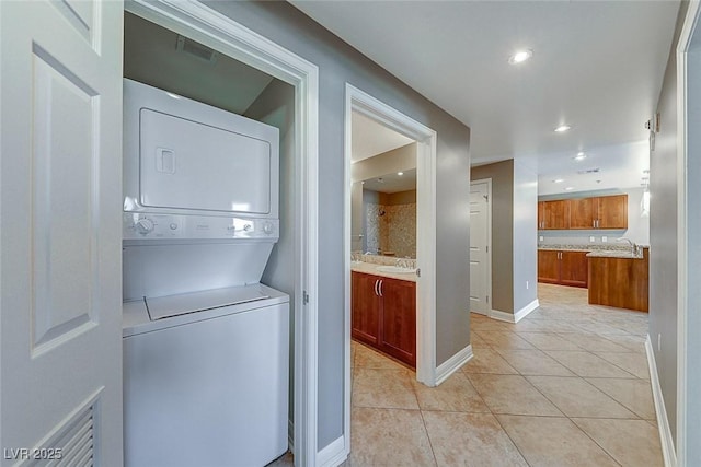 150 Las Vegas Blvd Unit 2016, North Las Vegas, NV 89101 - clothes washing area featuring stacked washer / dryer, light tile patterned floors, recessed lighting, and baseboards