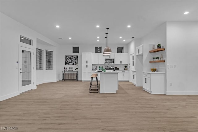 10801 Clarion Ln, Las Vegas, NV 89134 - kitchen featuring stainless steel appliances, open floor plan, light wood-style flooring, light countertops, and recessed lighting