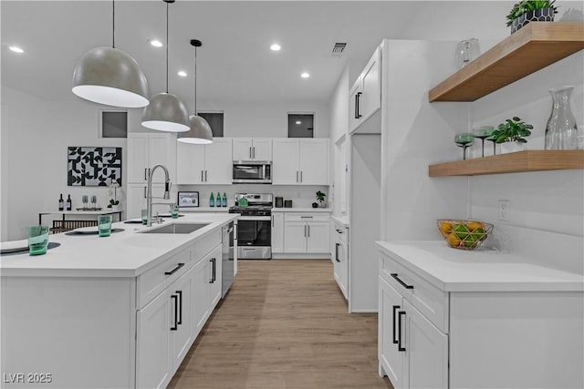 10801 Clarion Ln, Las Vegas, NV 89134 - kitchen with appliances with stainless steel finishes, a sink, open shelves, light countertops, and white cabinetry