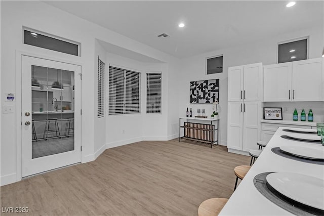10801 Clarion Ln, Las Vegas, NV 89134 - kitchen with recessed lighting, light countertops, white cabinetry, light wood-type flooring, and baseboards