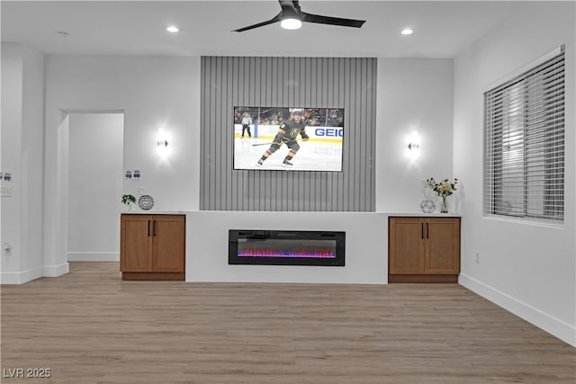 10801 Clarion Ln, Las Vegas, NV 89134 - living room featuring light wood-type flooring, baseboards, ceiling fan, recessed lighting, and a glass covered fireplace