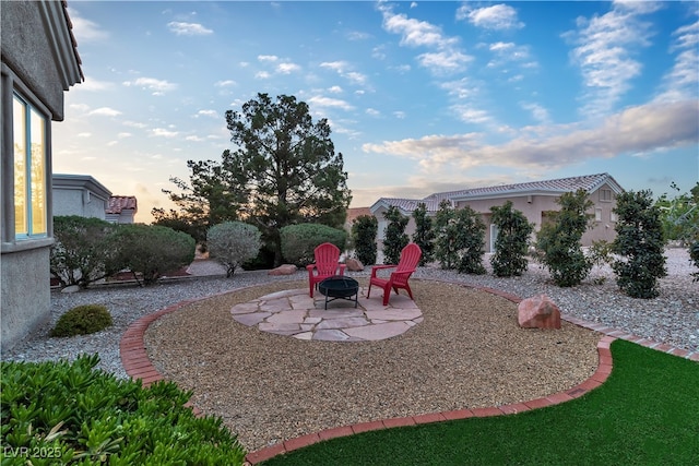 10801 Clarion Ln, Las Vegas, NV 89134 - yard at dusk featuring a fire pit and a patio