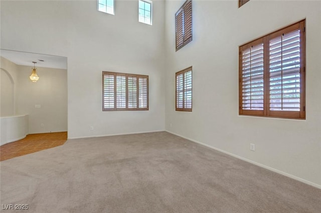 11444 Steponia Bay St, Las Vegas, NV 89141 - carpeted empty room featuring baseboards and a towering ceiling
