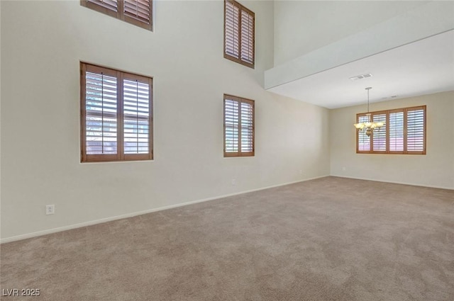 11444 Steponia Bay St, Las Vegas, NV 89141 - carpeted spare room featuring plenty of natural light, a chandelier, baseboards, and a towering ceiling