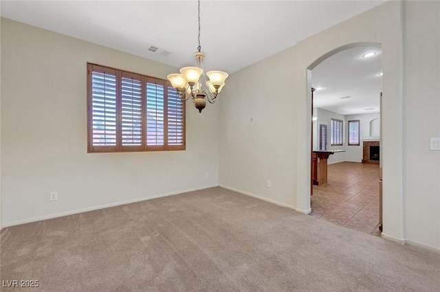 11444 Steponia Bay St, Las Vegas, NV 89141 - spare room featuring arched walkways, healthy amount of natural light, carpet floors, and a chandelier