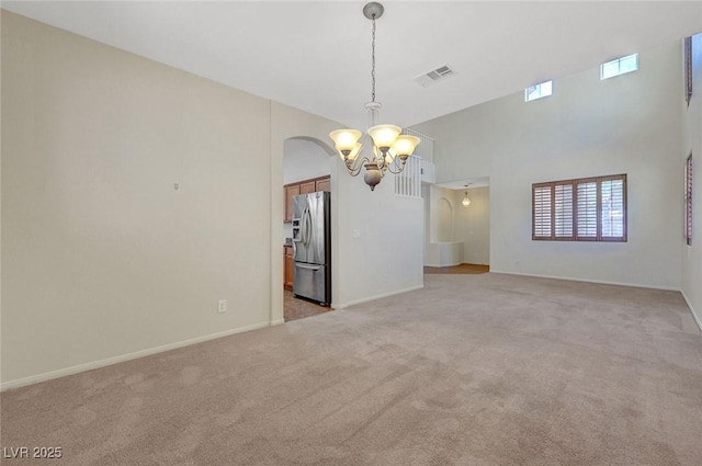 11444 Steponia Bay St, Las Vegas, NV 89141 - unfurnished room with a chandelier, light carpet, baseboards, and arched walkways