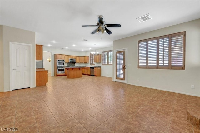 11444 Steponia Bay St, Las Vegas, NV 89141 - unfurnished living room featuring a ceiling fan, a chandelier, arched walkways, recessed lighting, and baseboards