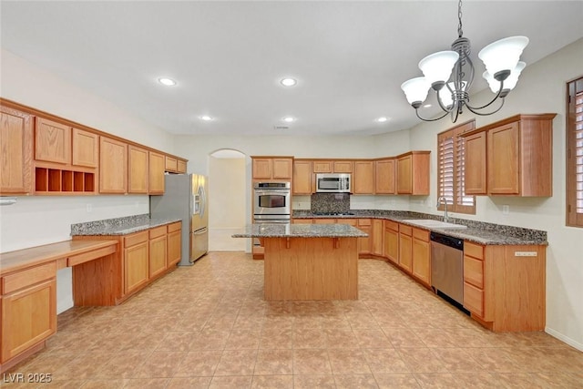 11444 Steponia Bay St, Las Vegas, NV 89141 - kitchen featuring appliances with stainless steel finishes, a sink, a center island, a chandelier, and dark stone counters