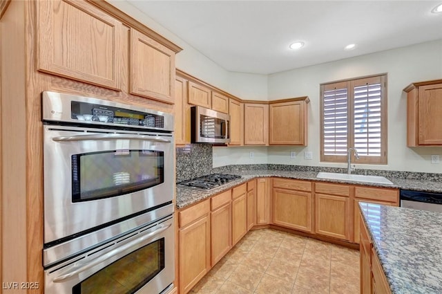 11444 Steponia Bay St, Las Vegas, NV 89141 - kitchen with a sink, stainless steel appliances, light brown cabinetry, recessed lighting, and stone countertops