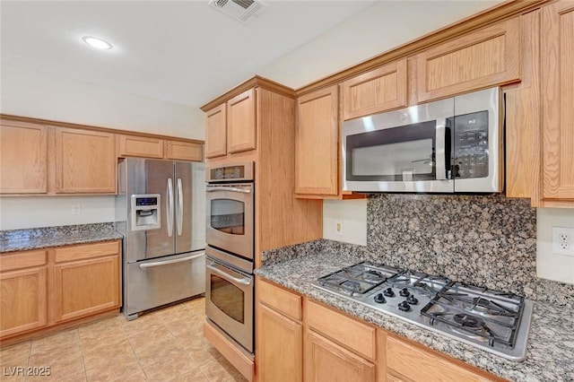 11444 Steponia Bay St, Las Vegas, NV 89141 - kitchen with appliances with stainless steel finishes, tasteful backsplash, light stone counters, and light tile patterned flooring