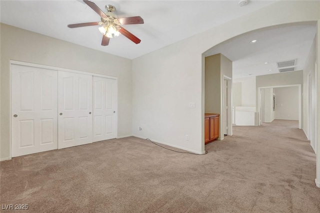 11444 Steponia Bay St, Las Vegas, NV 89141 - unfurnished bedroom featuring arched walkways, light carpet, a closet, and ceiling fan