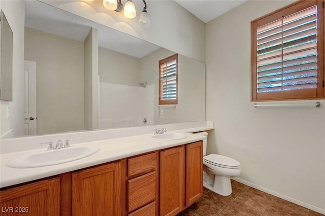 11444 Steponia Bay St, Las Vegas, NV 89141 - bathroom with toilet, baseboards, a shower, double vanity, and tile patterned floors