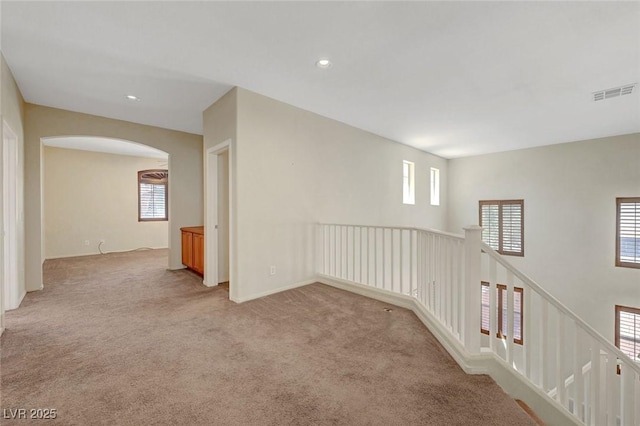 11444 Steponia Bay St, Las Vegas, NV 89141 - unfurnished room with light colored carpet, arched walkways, recessed lighting, and baseboards