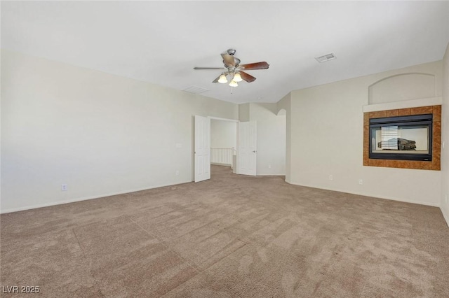 11444 Steponia Bay St, Las Vegas, NV 89141 - carpeted spare room featuring a ceiling fan, a tiled fireplace, and baseboards