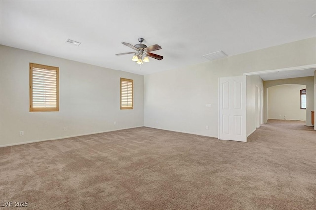 11444 Steponia Bay St, Las Vegas, NV 89141 - spare room with arched walkways, a ceiling fan, healthy amount of natural light, and light carpet