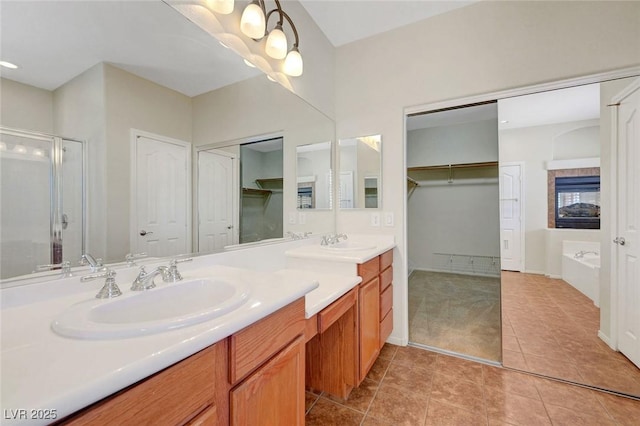 11444 Steponia Bay St, Las Vegas, NV 89141 - bathroom with tile patterned floors, a stall shower, vanity, a bath, and a walk in closet