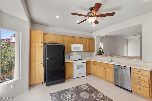 kitchen featuring white appliances, a sink, light countertops, healthy amount of natural light, and recessed lighting