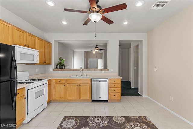 kitchen with white appliances, a sink, a ceiling fan, light countertops, and recessed lighting
