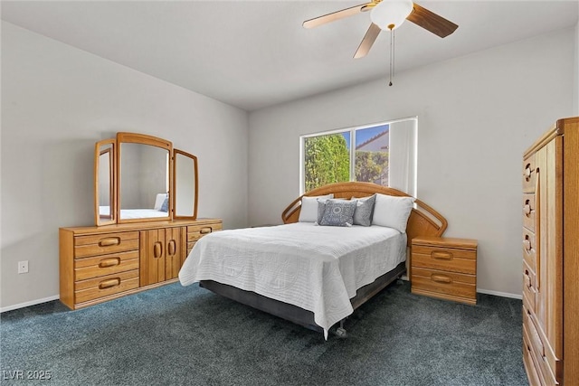 bedroom featuring dark colored carpet and a ceiling fan