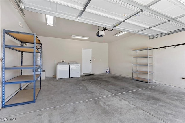 garage with washing machine and dryer and a garage door opener