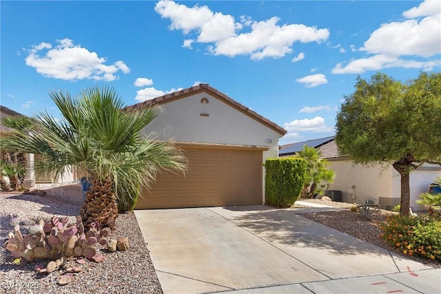 view of property exterior with stucco siding, driveway, a garage, and a tile roof