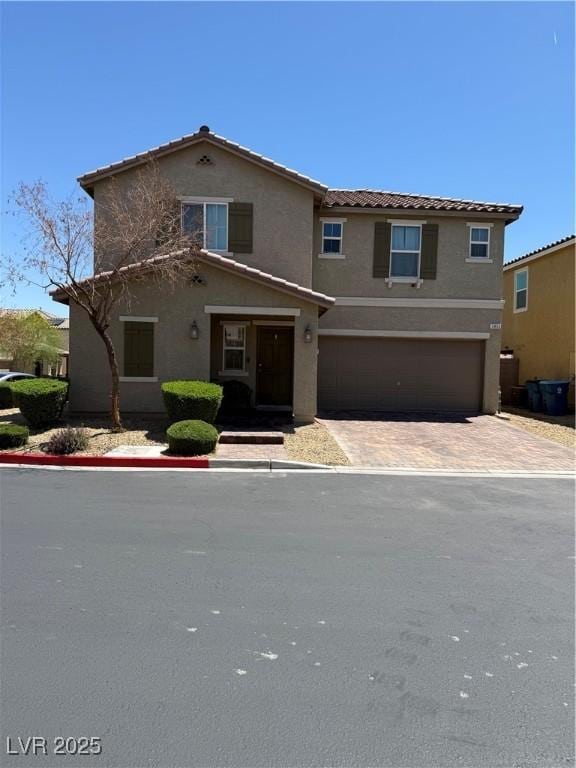 3855 Park Field Dr, Las Vegas, NV 89120 - view of front of home with stucco siding, an attached garage, a tiled roof, and decorative driveway