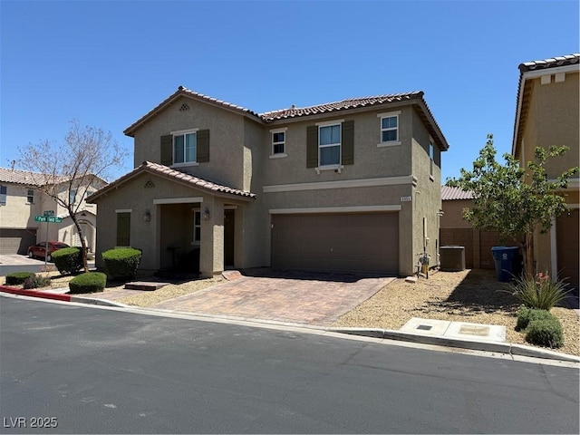 3855 Park Field Dr, Las Vegas, NV 89120 - view of front of home featuring stucco siding, cooling unit, a garage, decorative driveway, and a tiled roof