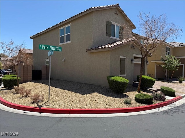 3855 Park Field Dr, Las Vegas, NV 89120 - view of side of property featuring stucco siding and a tile roof