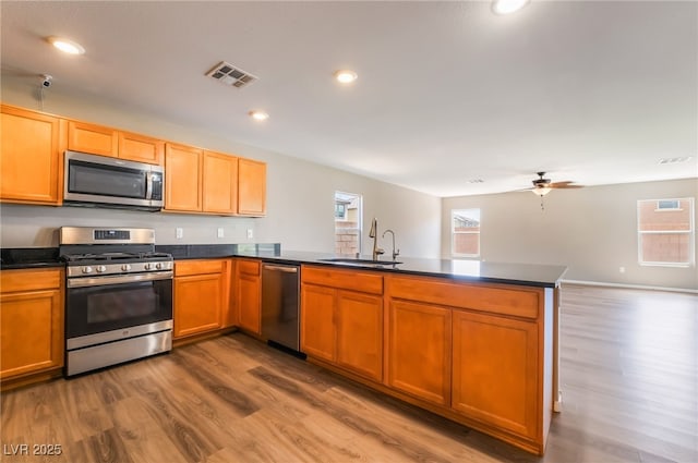 3855 Park Field Dr, Las Vegas, NV 89120 - kitchen with appliances with stainless steel finishes, a peninsula, a sink, healthy amount of natural light, and recessed lighting